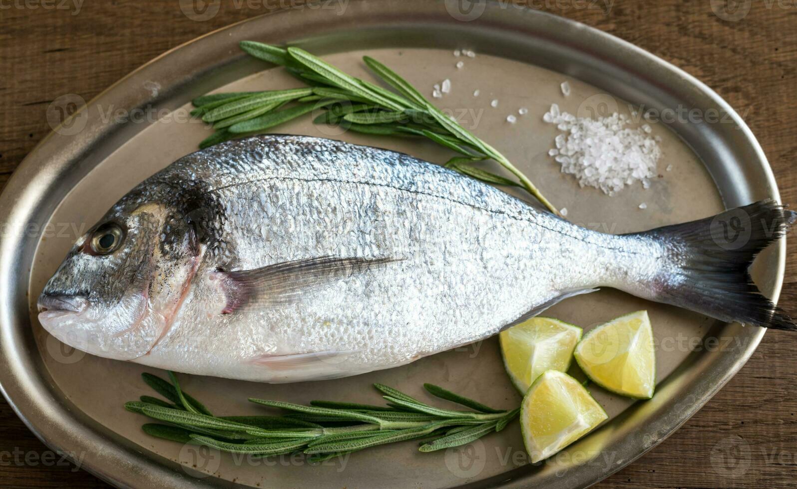 Fresh dorada with ingredients on the vintage tray photo