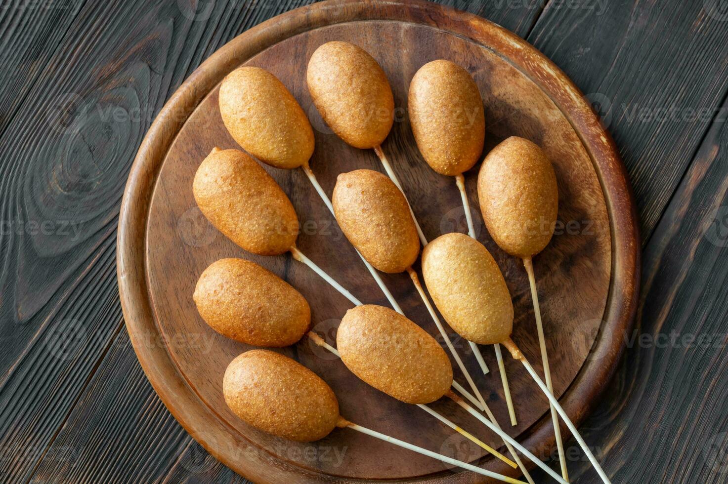 Corn dogs on wooden board photo