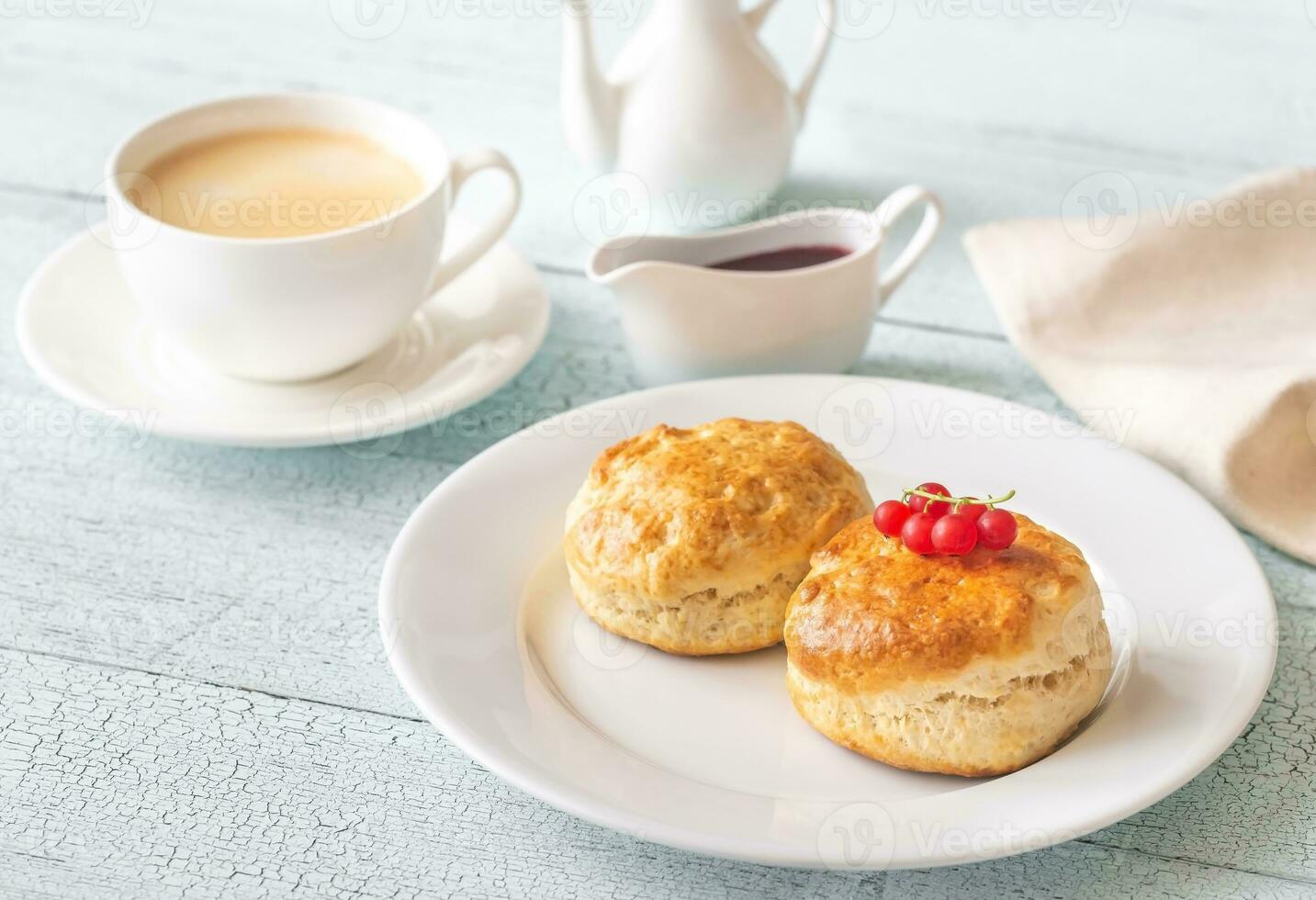 Classic scones with cream and berry jam photo