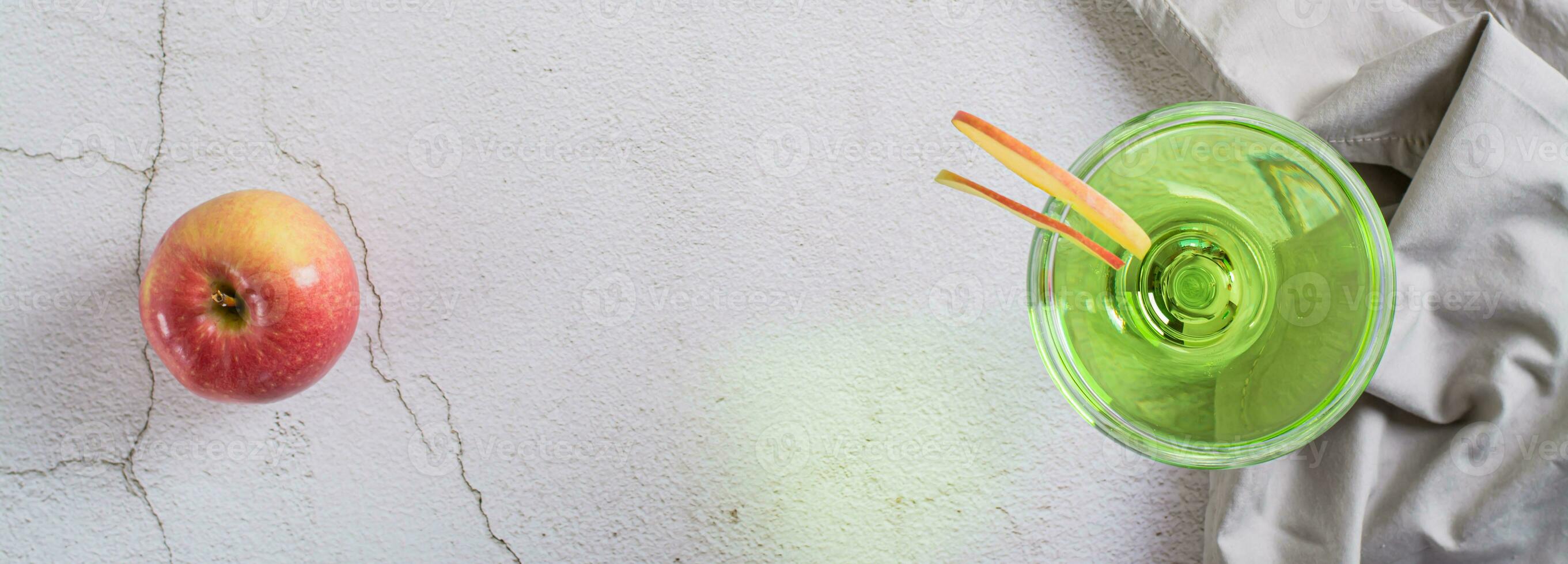 Refreshing apple martini with fruit in glasses on the table top view web banner photo