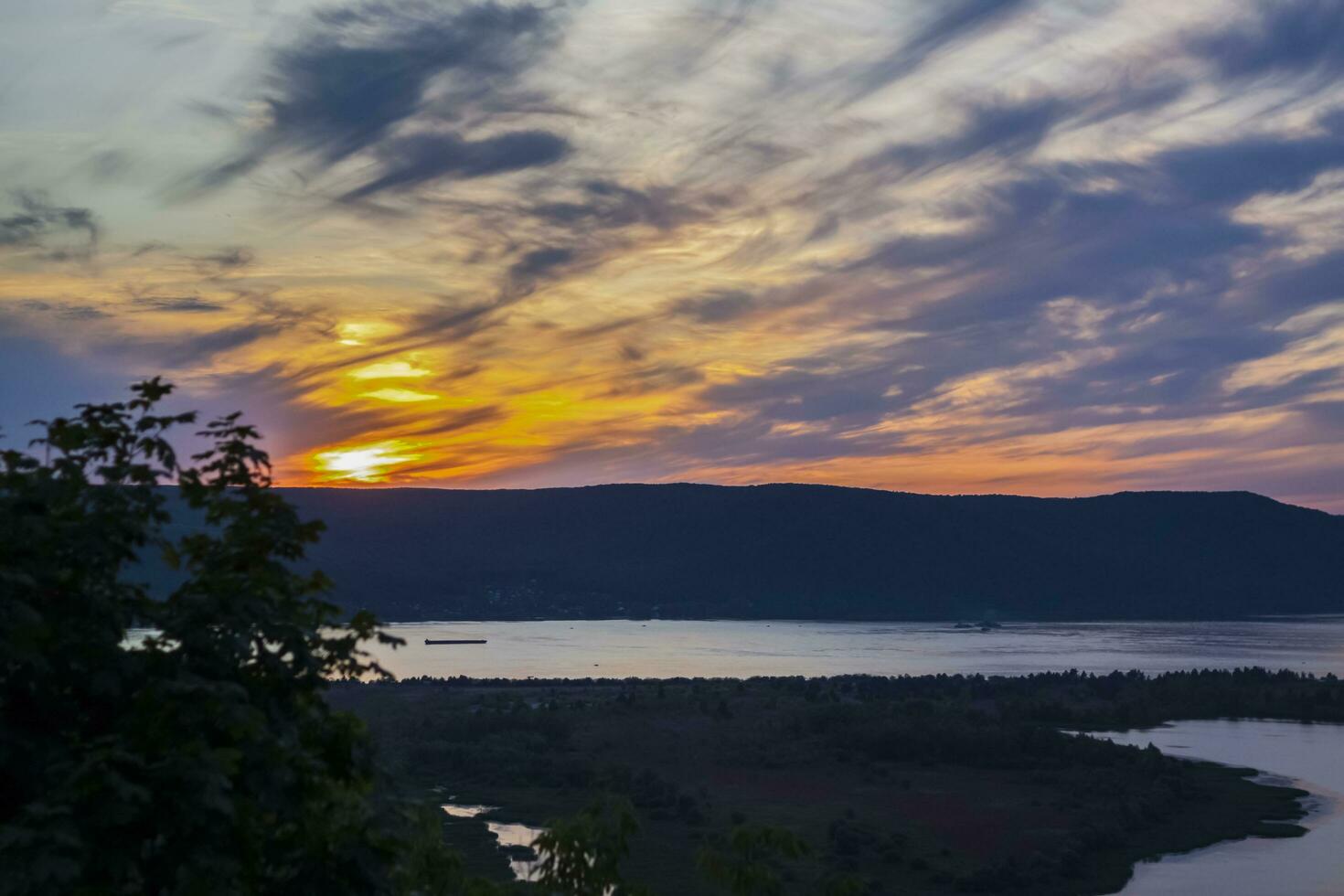 sunset on the Volga river. Natural landscape. reflection, blue sky and yellow sunlight. landscape during sunset. photo