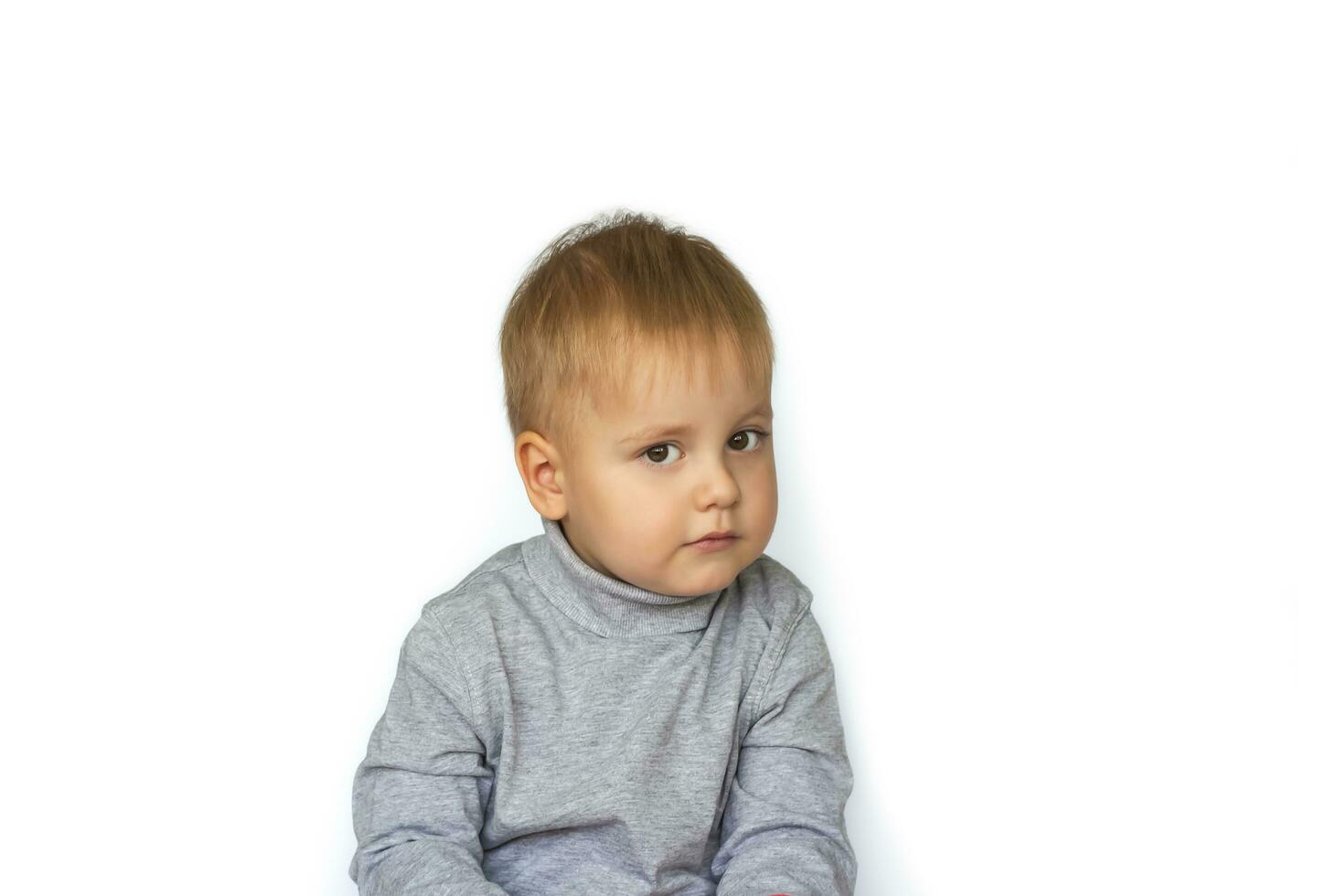 Portrait of a cute little boy. The child is isolated on a white background. Success, bright idea, creative ideas and innovative technological concepts. photo