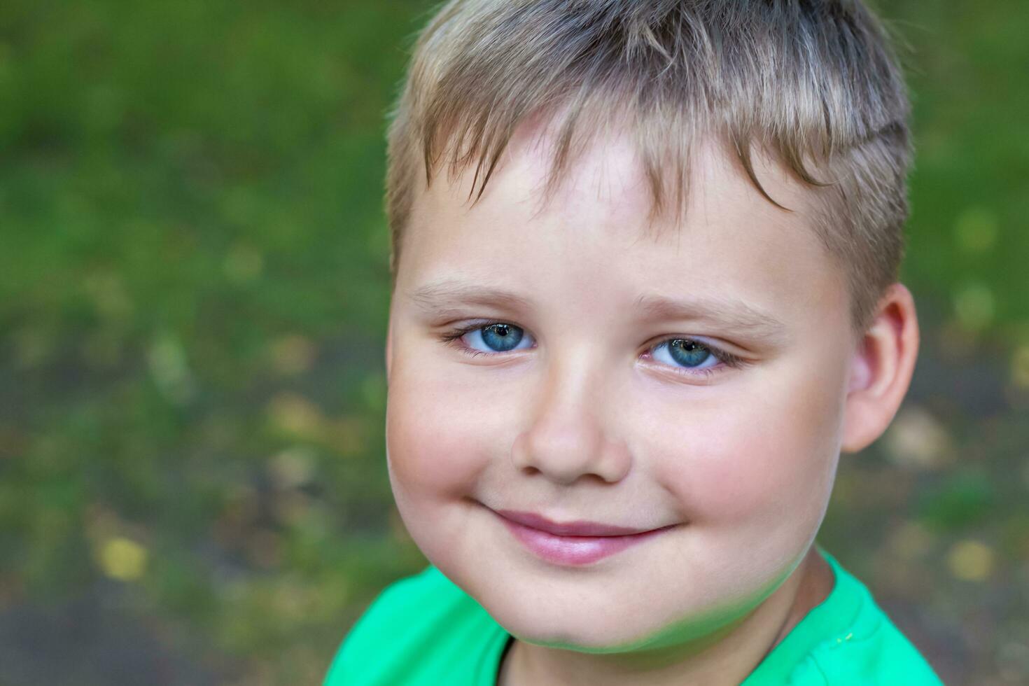 Close-up of a beautiful boy. Beautiful azure eye color. photo