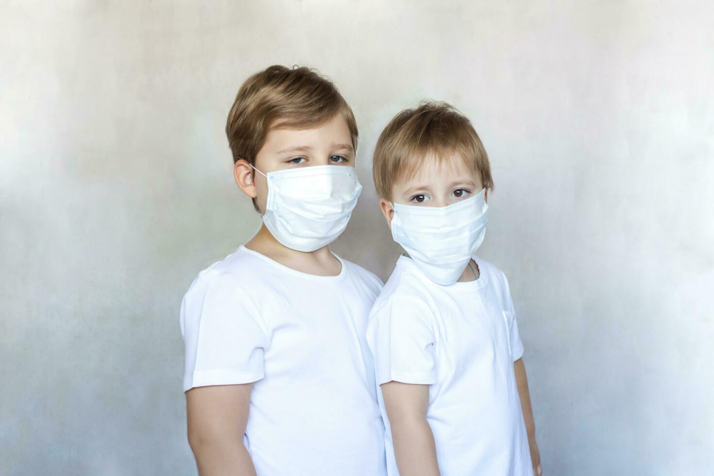 Boys-brothers in medical masks. Coronavirus, disease, infection, quarantine, medical mask, COVID-19. Quarantine and protection from influenza viruses and epidemics covid-19. photo