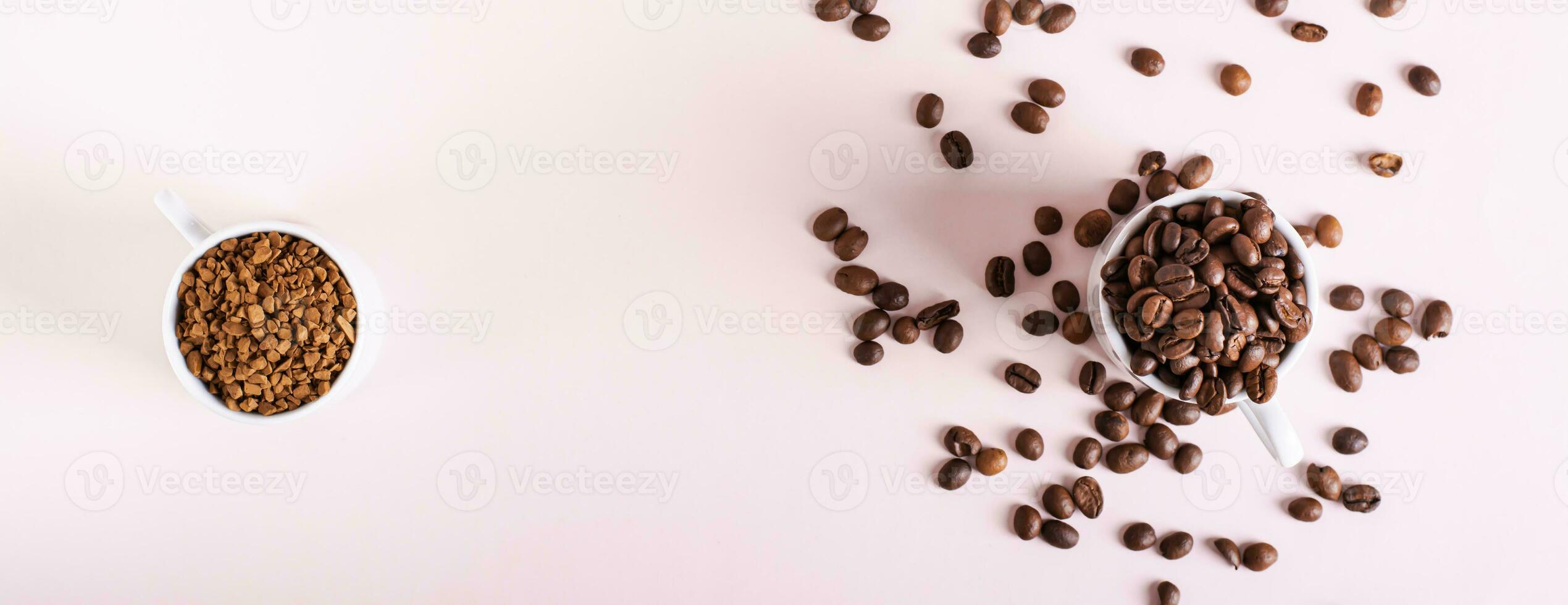 Choice between instant coffee and roasted coffee beans in cups on pink top view web banner photo