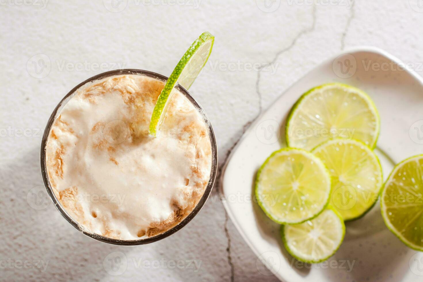 Close up of homemade dirty soda with cola and lime in a glass on the table top view photo