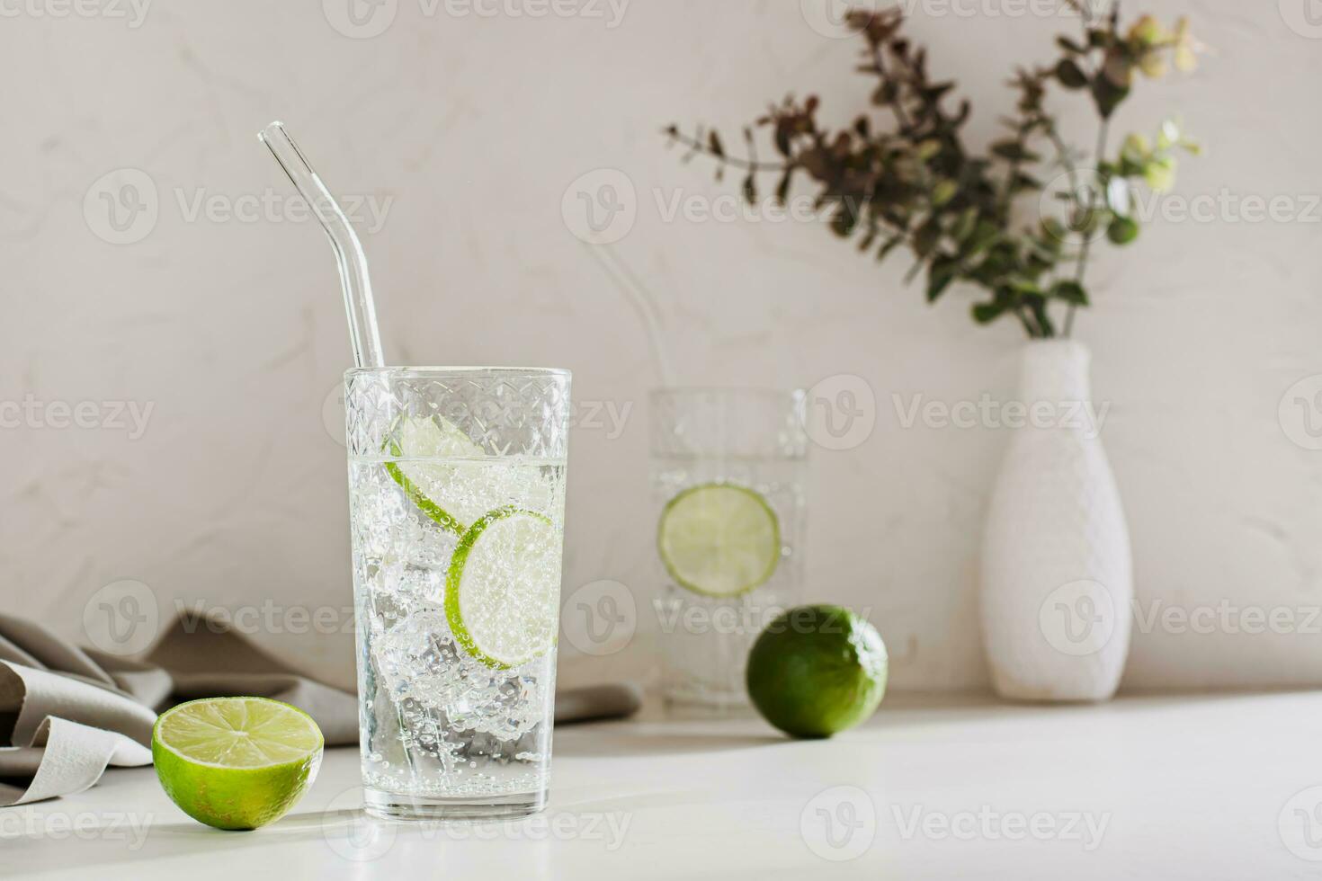 Sparkling mineral water with ice and lime in glasses for refreshment in the summer heat photo
