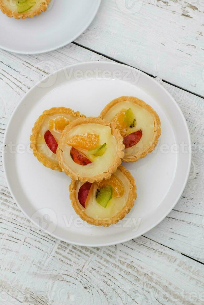 Small fruit pia cake on a textured white background. Kue Pia Buah. photo