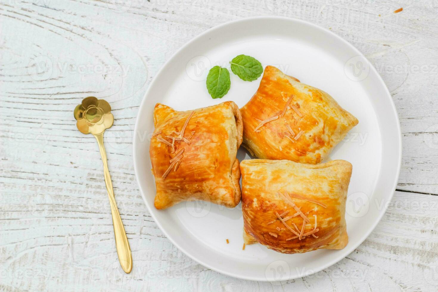 Banana Bolen Cake on a white plate on a wooden background. Bolen Pisang. photo