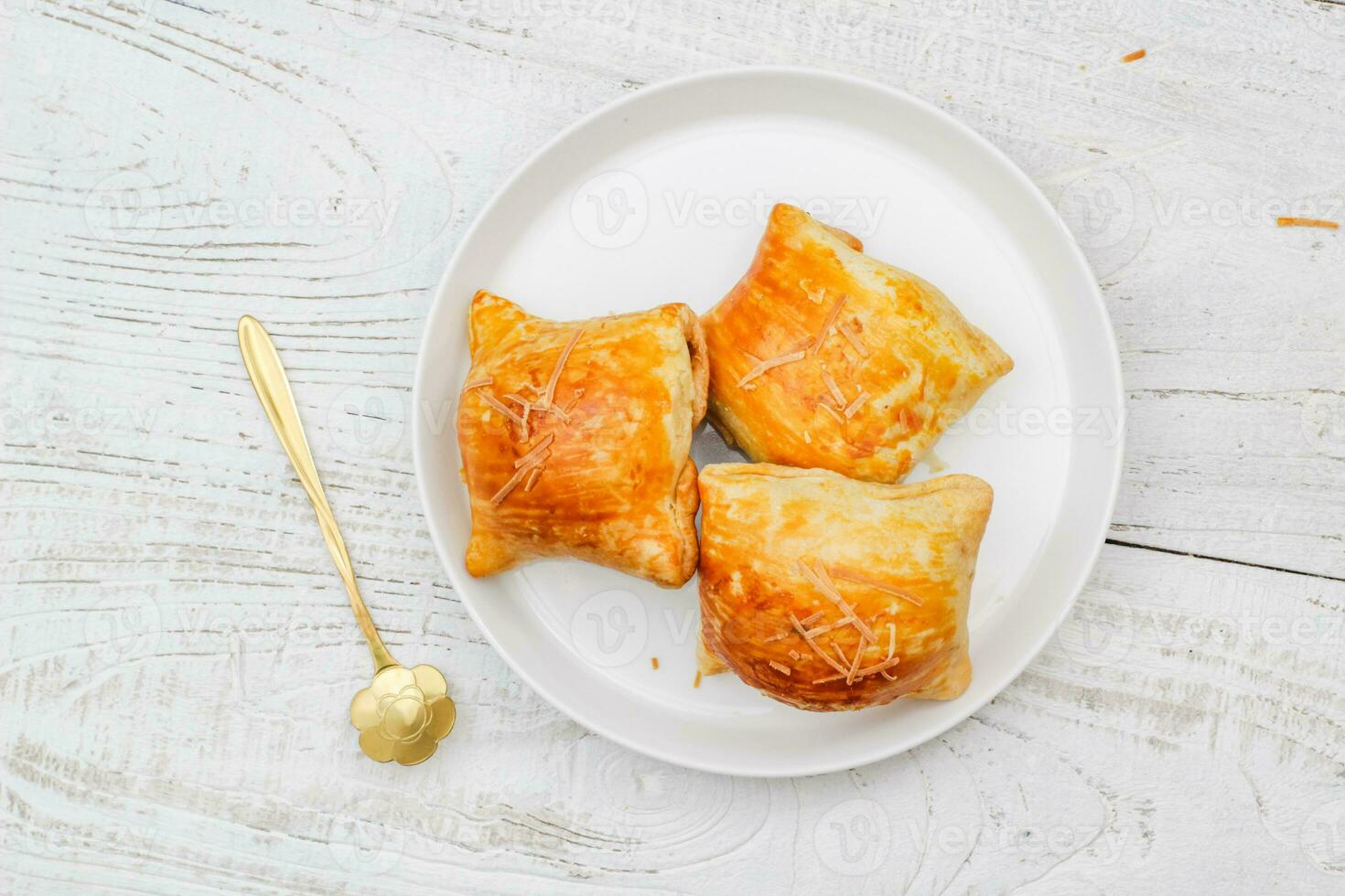 Banana Bolen Cake on a white plate on a wooden background. Bolen Pisang. photo