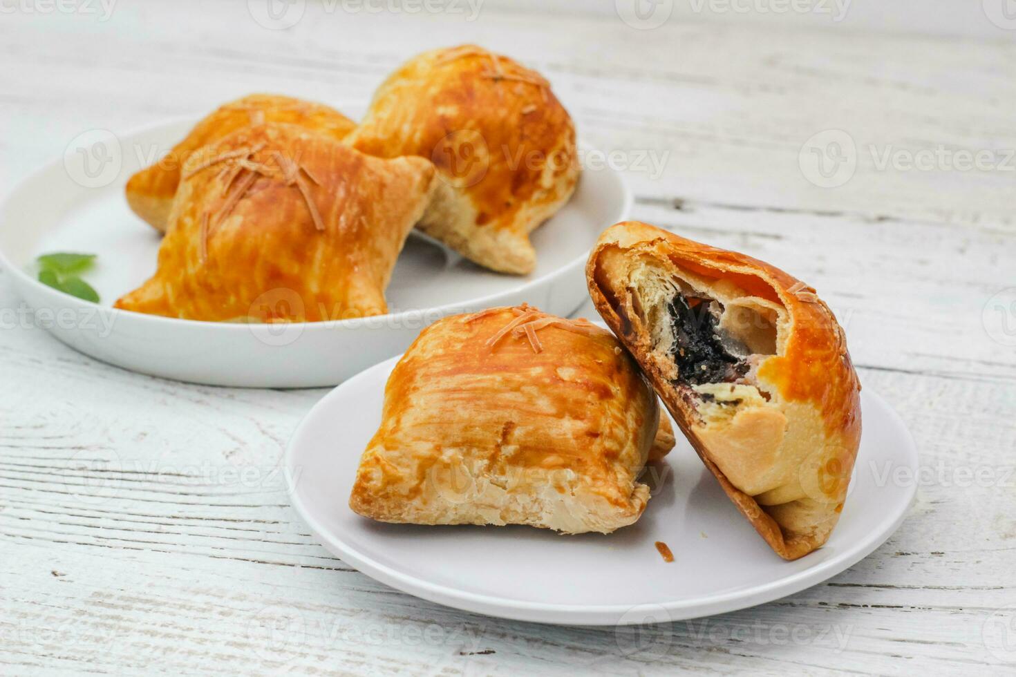 Banana Bolen Cake on a white plate on a wooden background. Bolen Pisang. photo