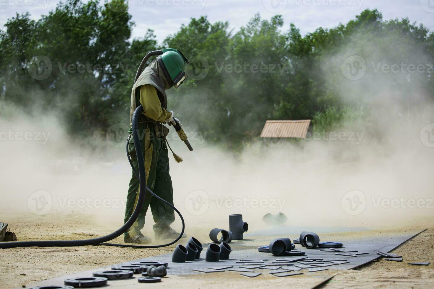 Male worker Sand blasting process cleaning pipeline surface 24228547