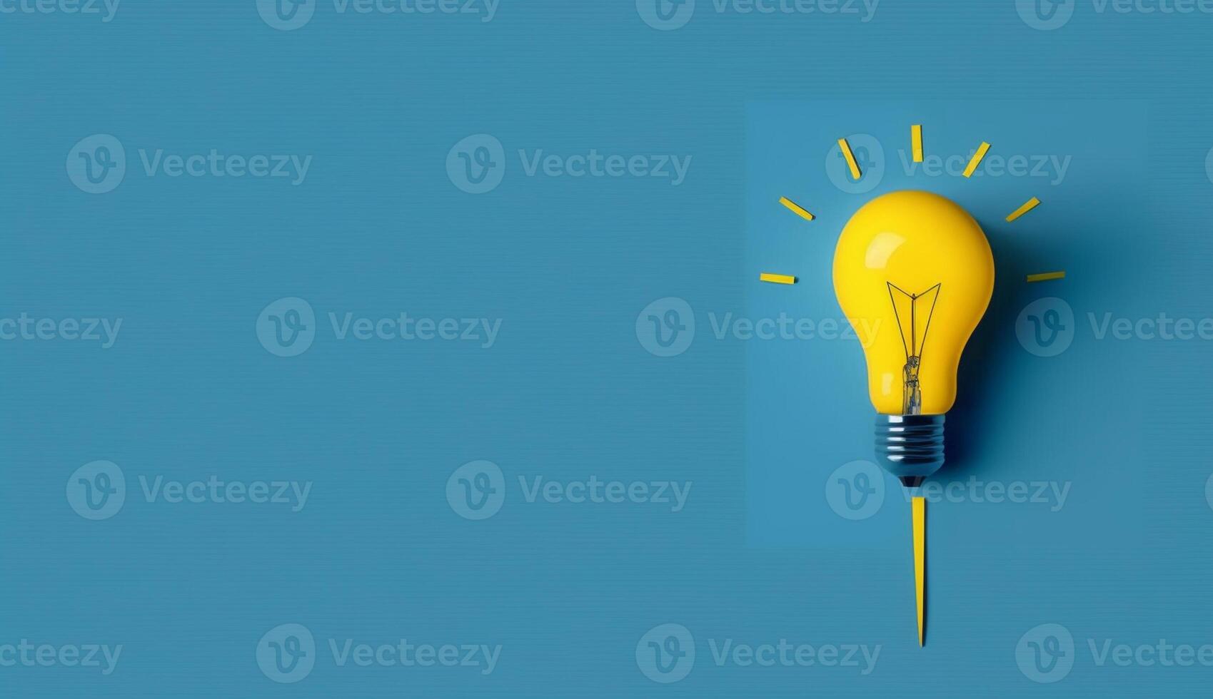 Idea concept with yellow light bulb on blue background, photo