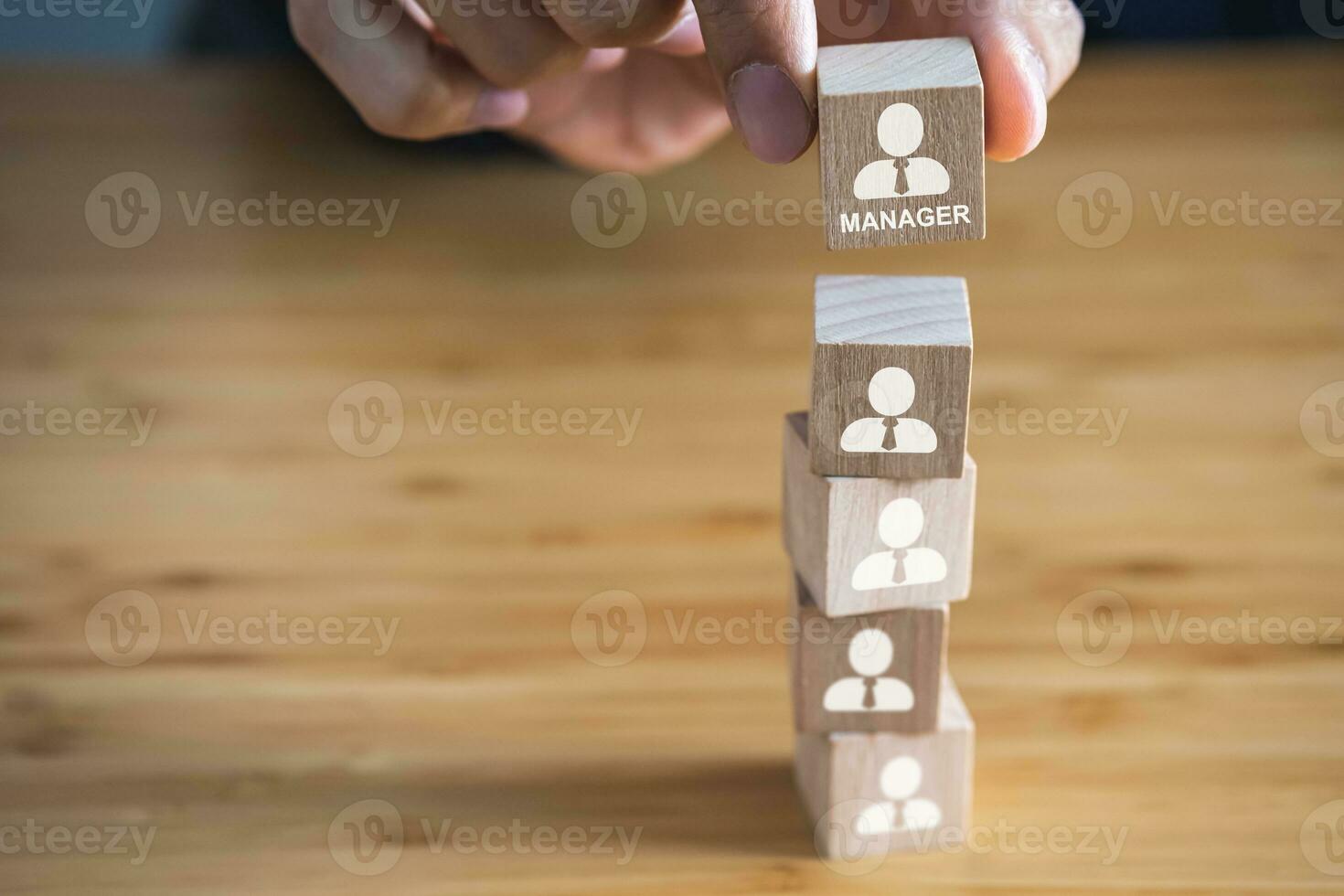 Wooden block with employee icons. Manager is on the top of employees. Business, company organization and teamwork concept. photo