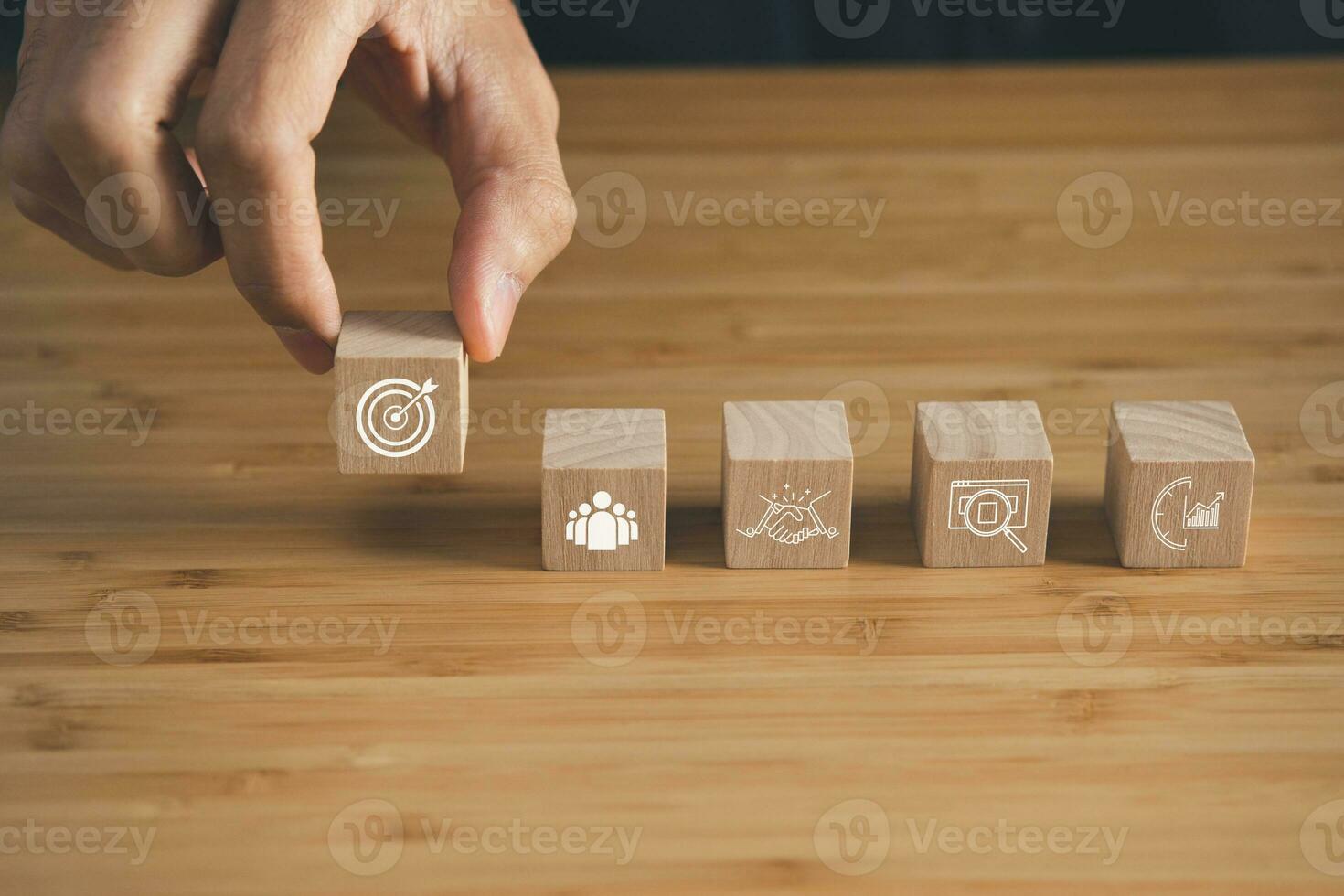 Wooden block with business strategy and goal icons. key performance indicator and businees achievement goal concept. photo