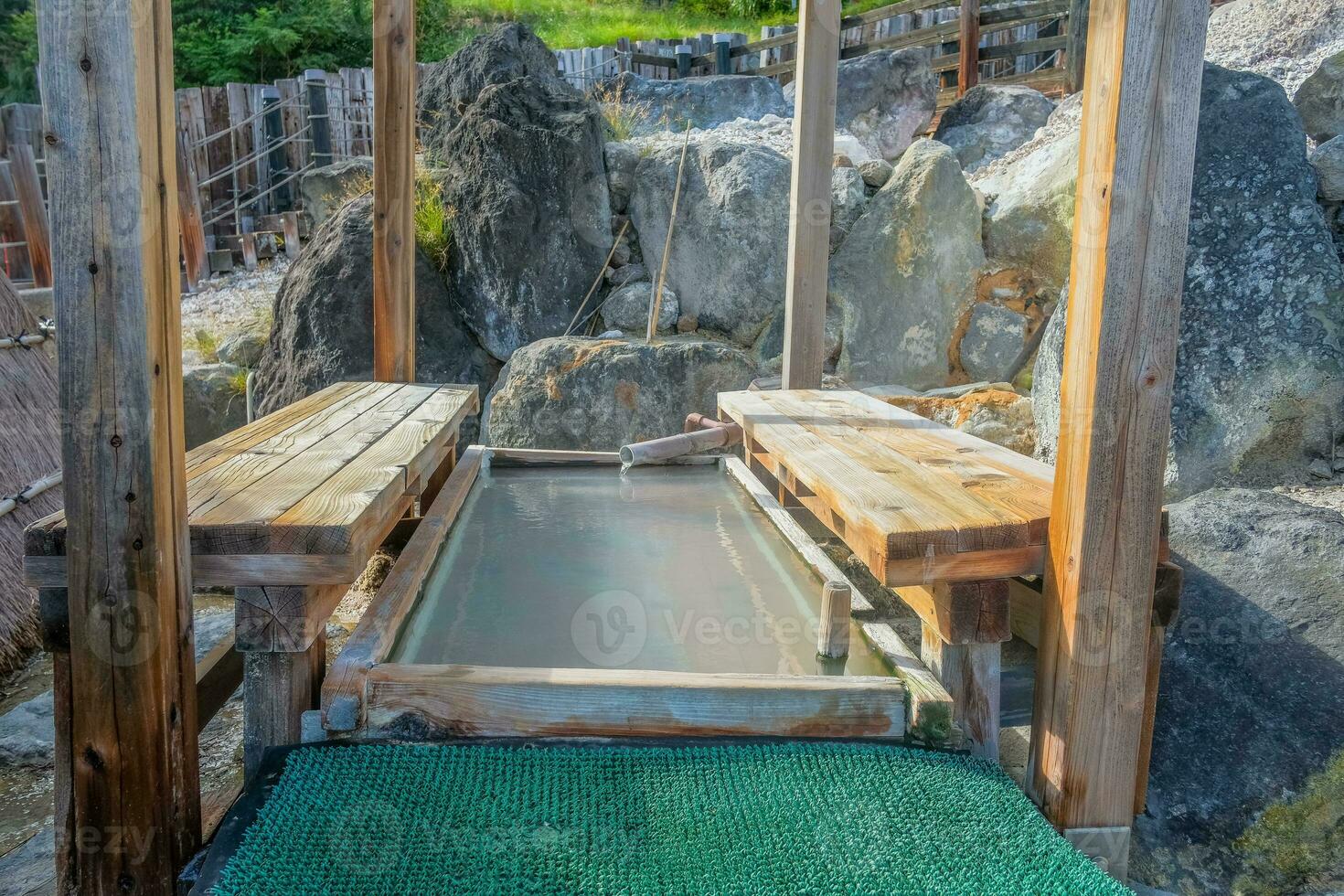 Foot bath hot spring onsen, Myoban Jigoku, straw huts produce sulfur based bath salts photo