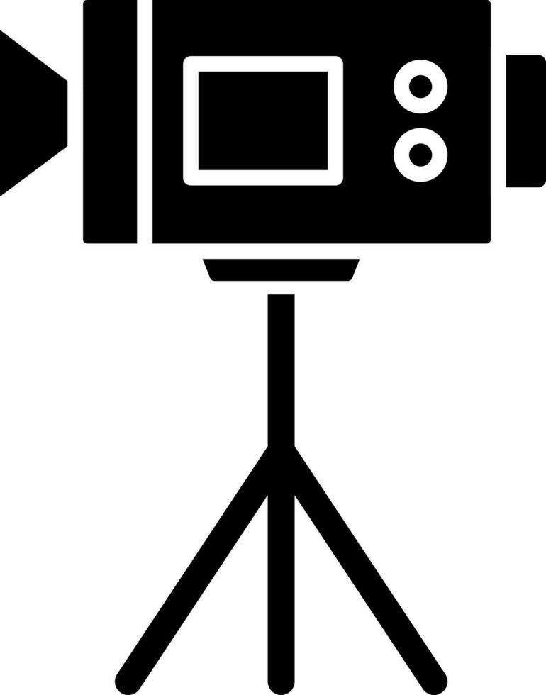 Video camera on tripod glyph icon. vector