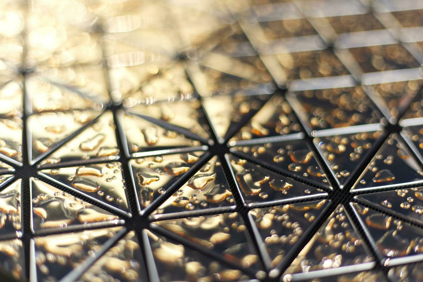 close up of a glass mirror tile with water marks background 24255345