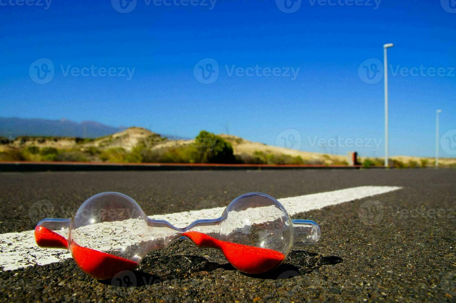 Hourglass on the road photo