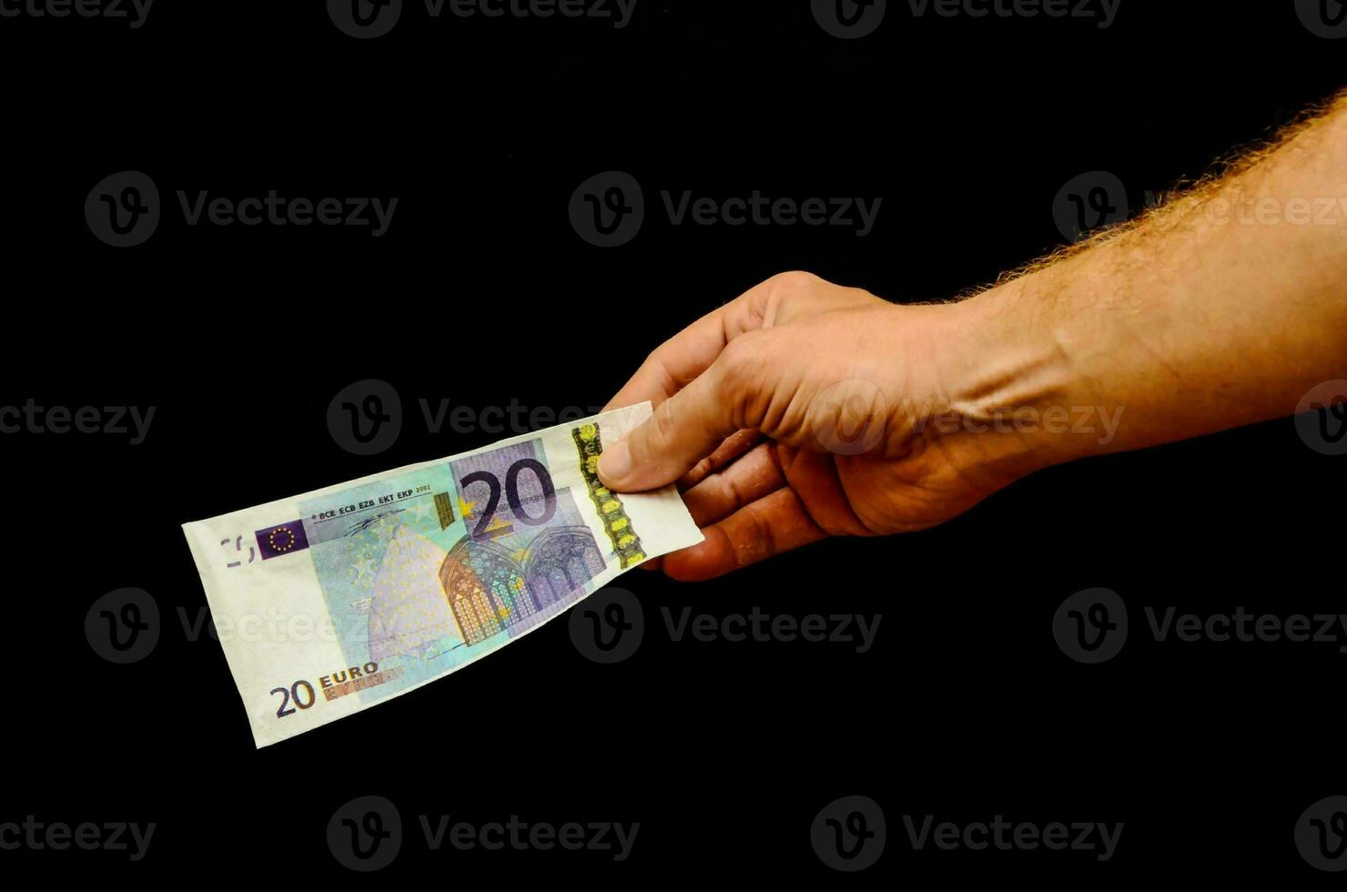 Hand holding a 20 euro bill photo