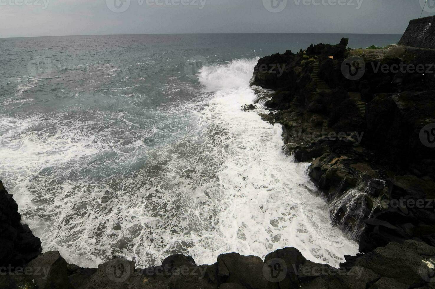 Waves hitting rocks photo