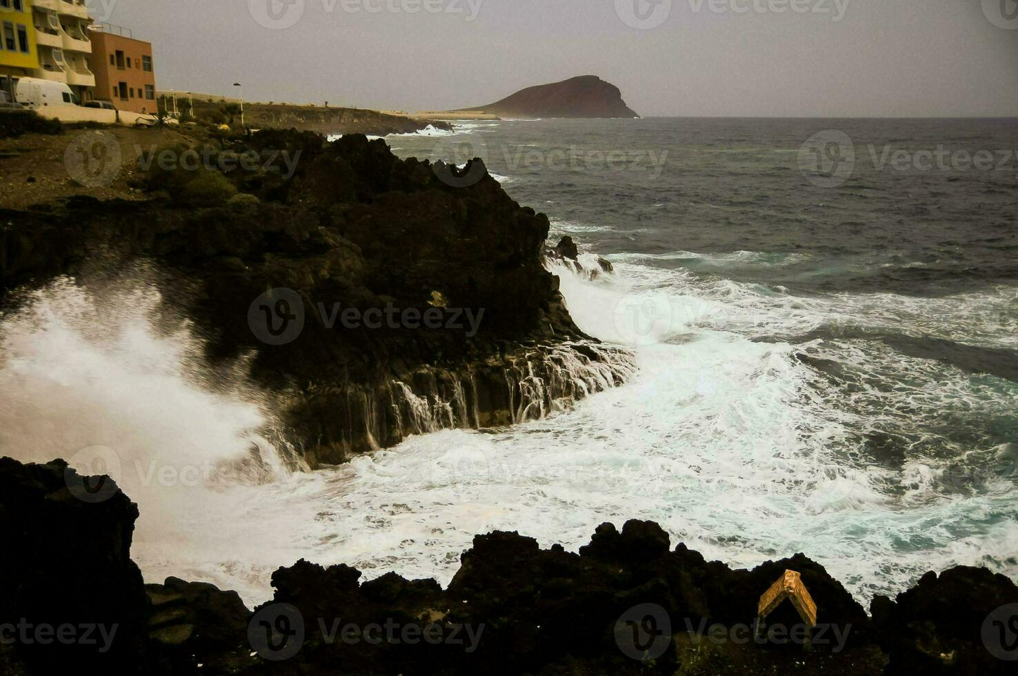 Waves hitting rocks photo