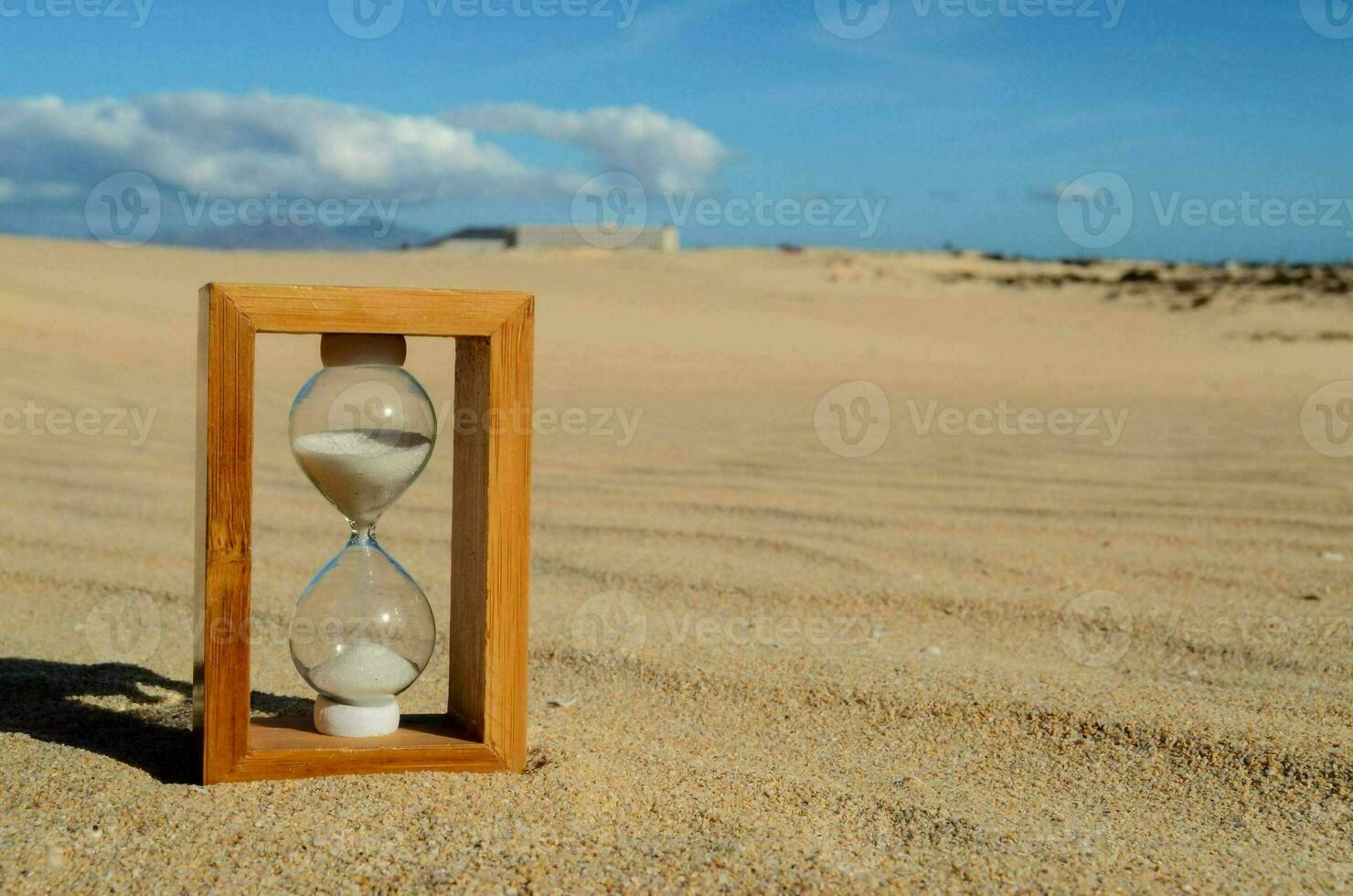 Hourglass on the sand photo