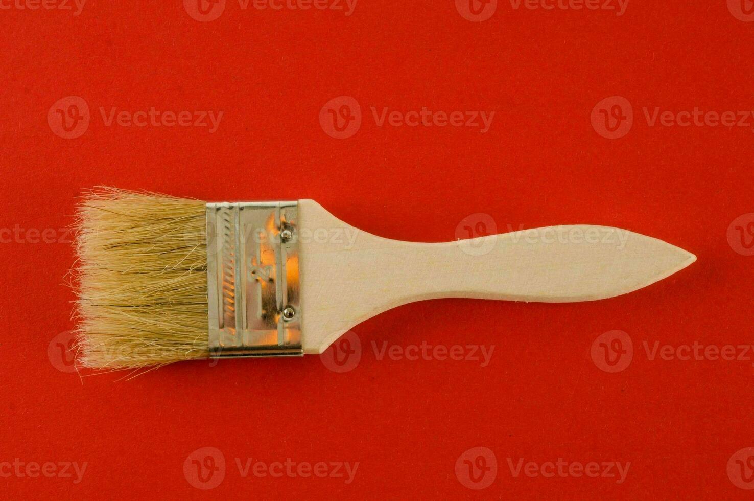 Paint brush on red background photo