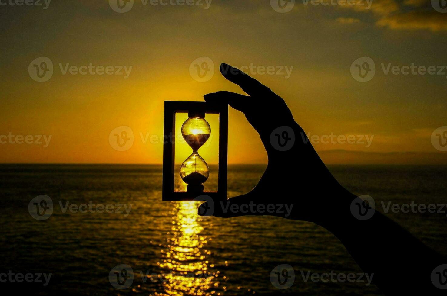 Hourglass in hand photo