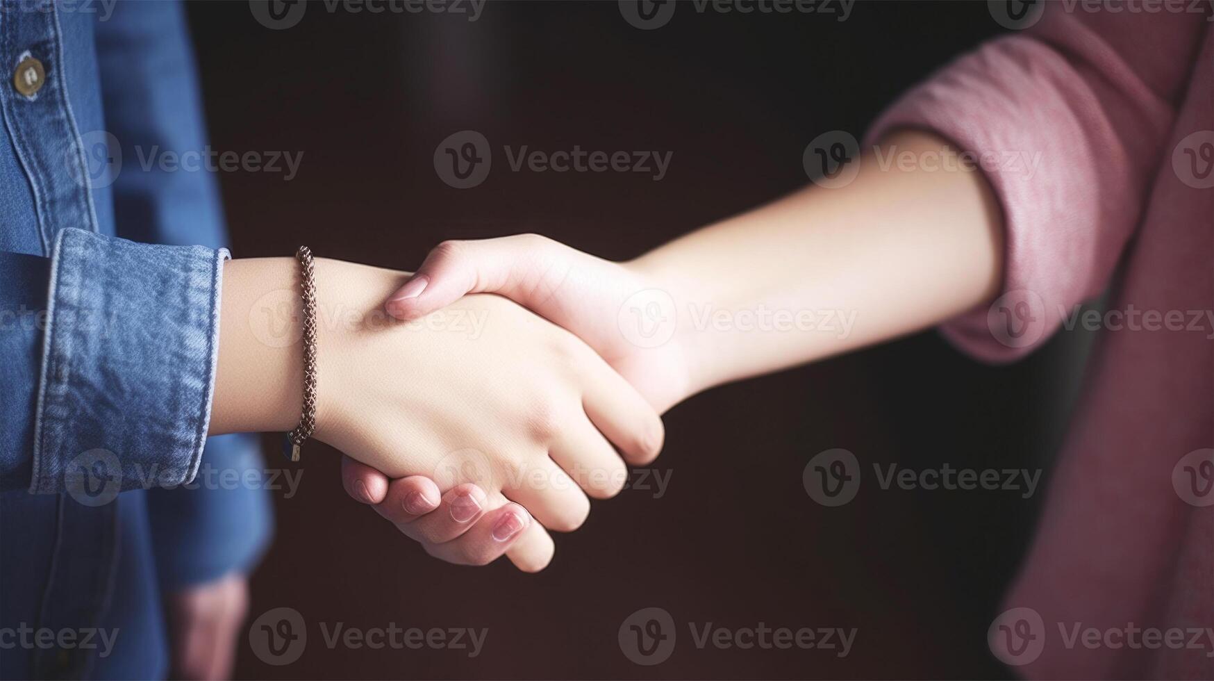 Friendly or casual handshake between two women. Close up. . photo