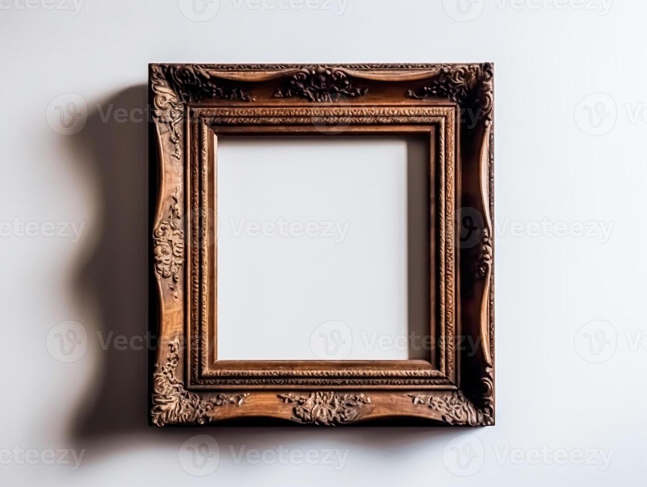 Antique empty wooden square frame on a white wall. photo