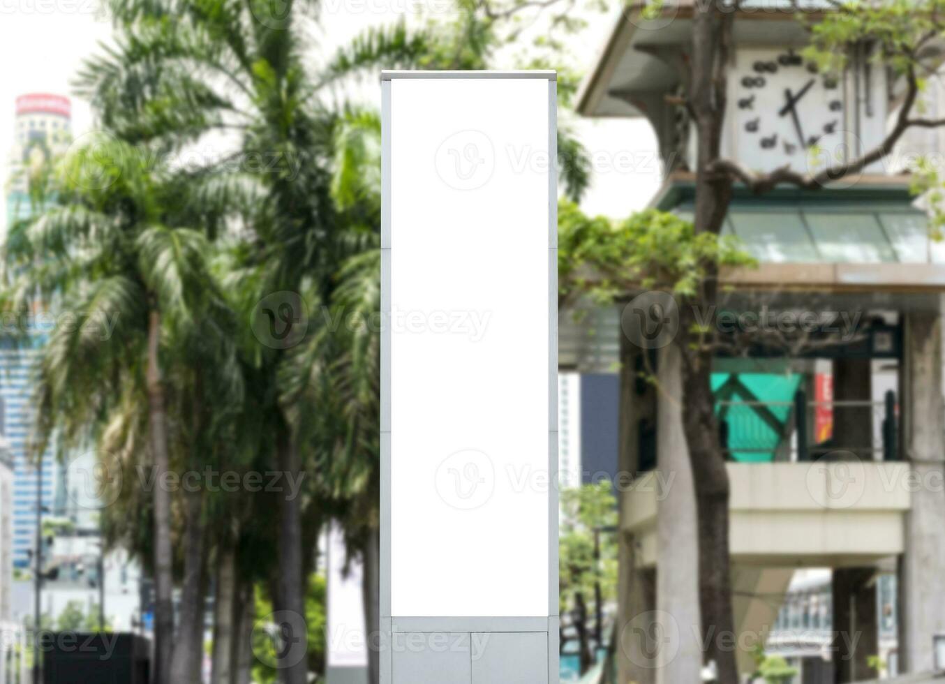 Mock up white LED display vertical billboard on tower pole with cityscape view. clipping path for mockup photo