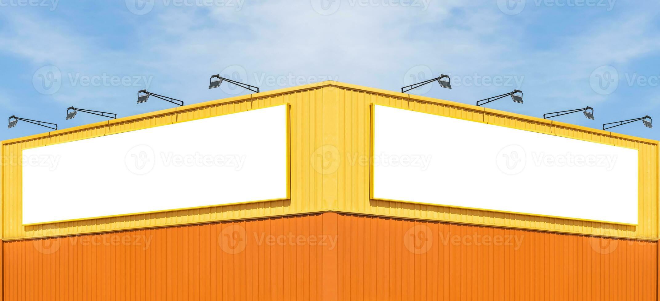 Mock up white background billboard on yellow building with blue sky background photo