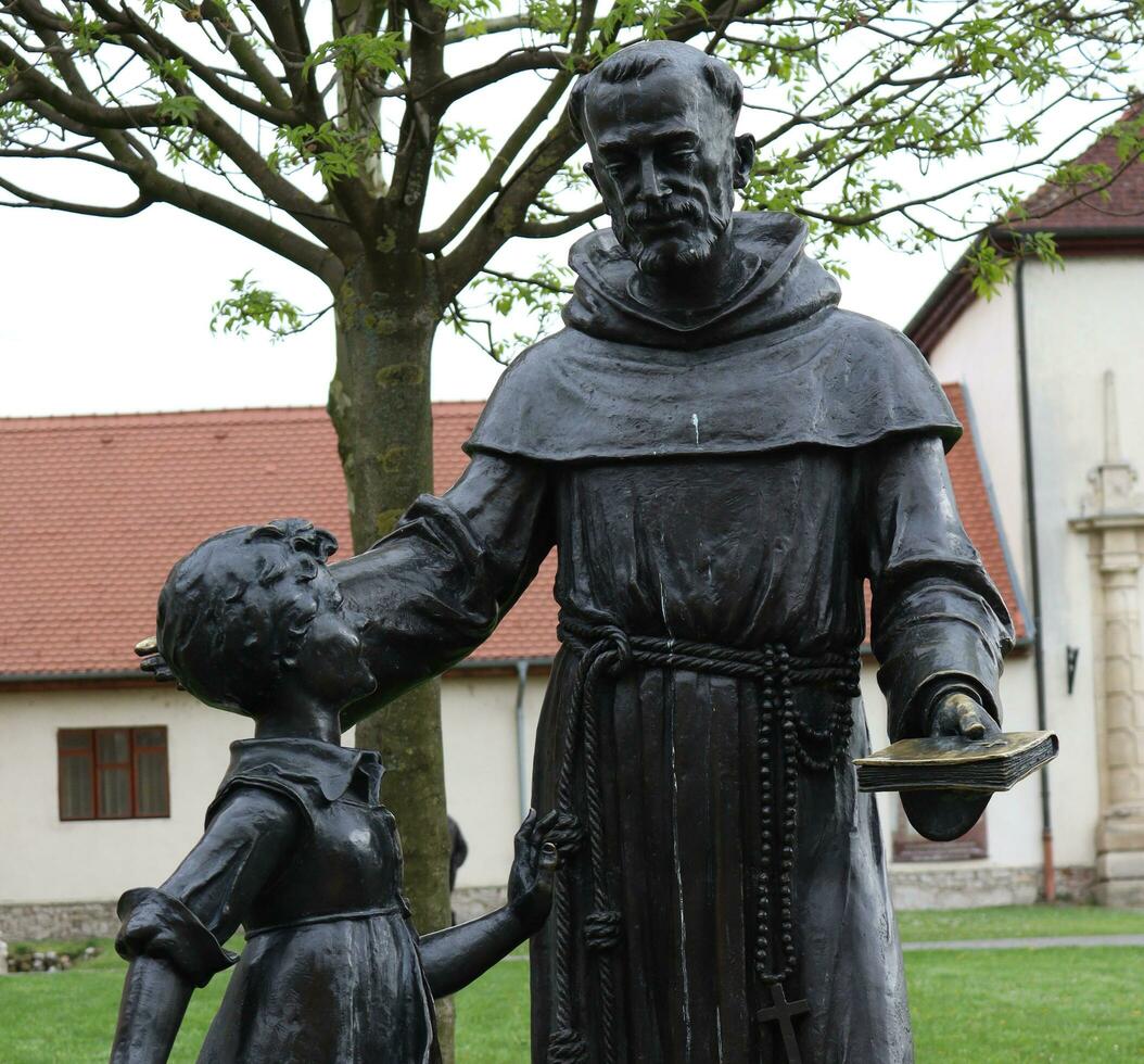 Alba Iulia , Romania - May 1 2023 , The multitude of statues made of bronze that can be found near the center of the fortress.This statues present different status of the people back days photo