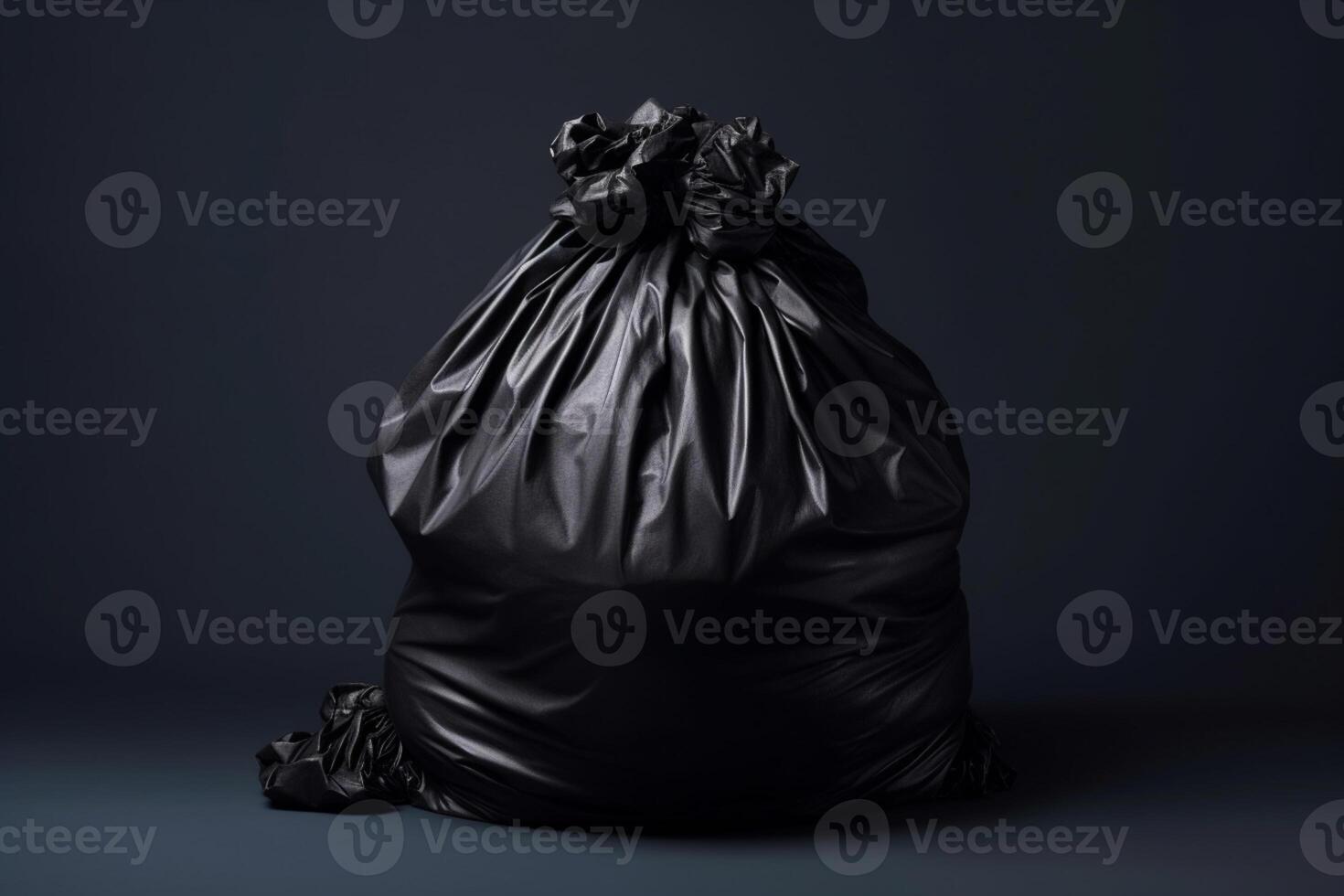 Black trash bag isolated on black background. photo