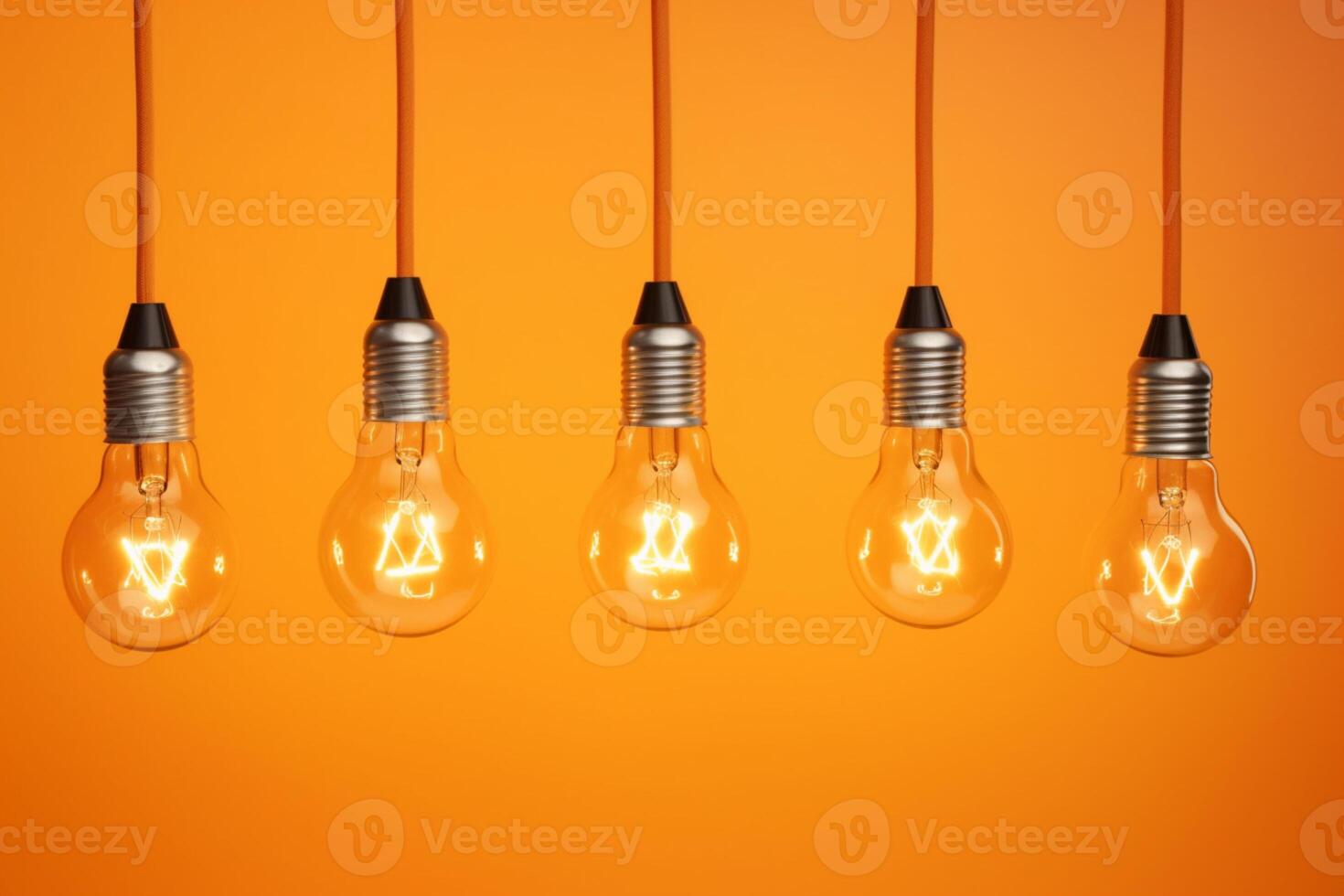 Idea concept on light bulb hanging on orange background, photo