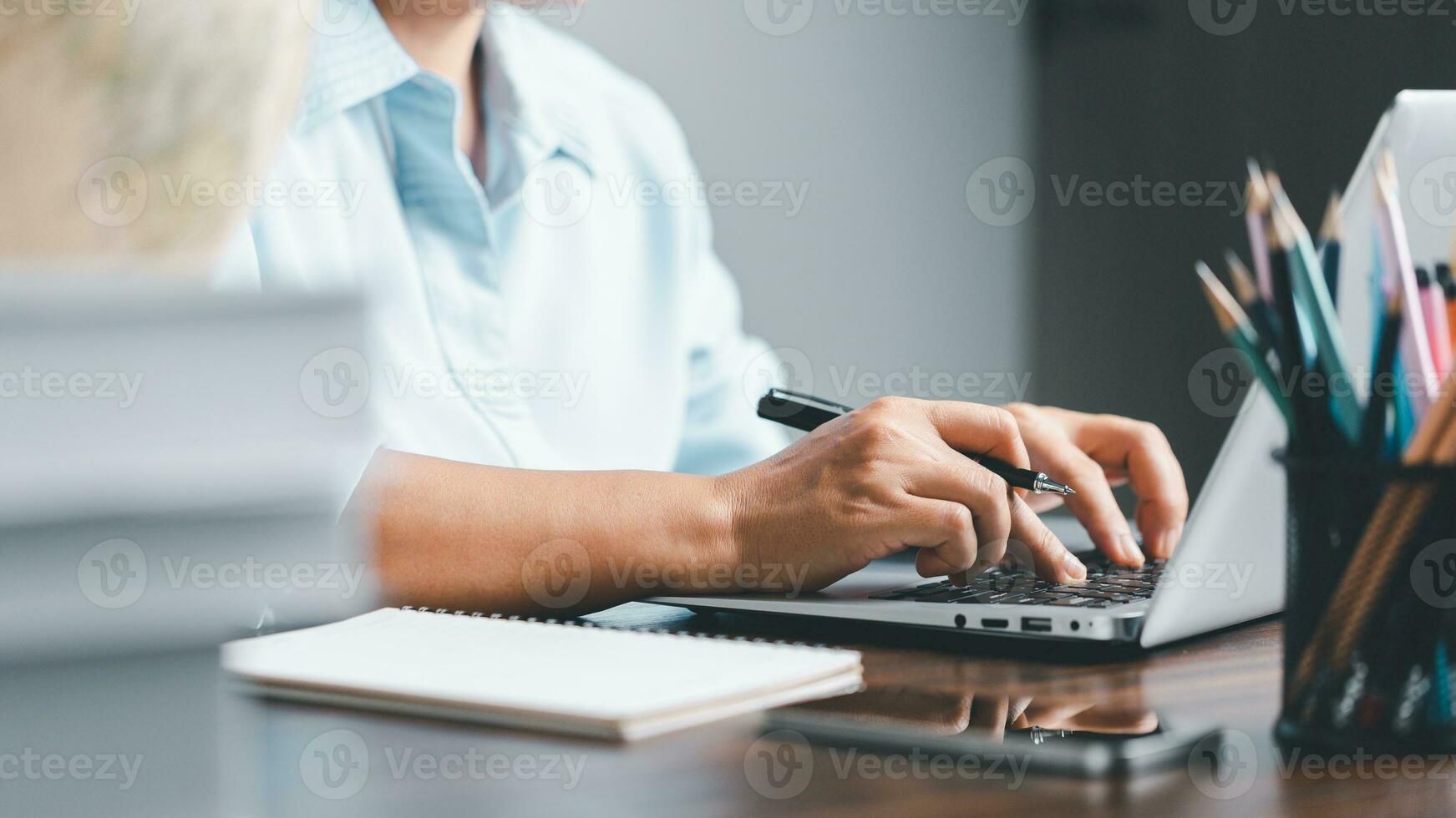 Education concept. Close up of female student make notes hand typing in laptop study online on computer from home. Woman typing in computer talking distant on webcam virtual zoom call on laptop. photo