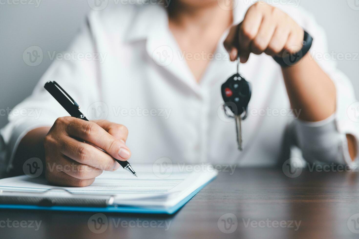 Car key for Vehicle Sales Agreement. New carowners are taking keys from male salespeople. Concept of car insurance business, saving buy - sale with tax and loan for new car. photo