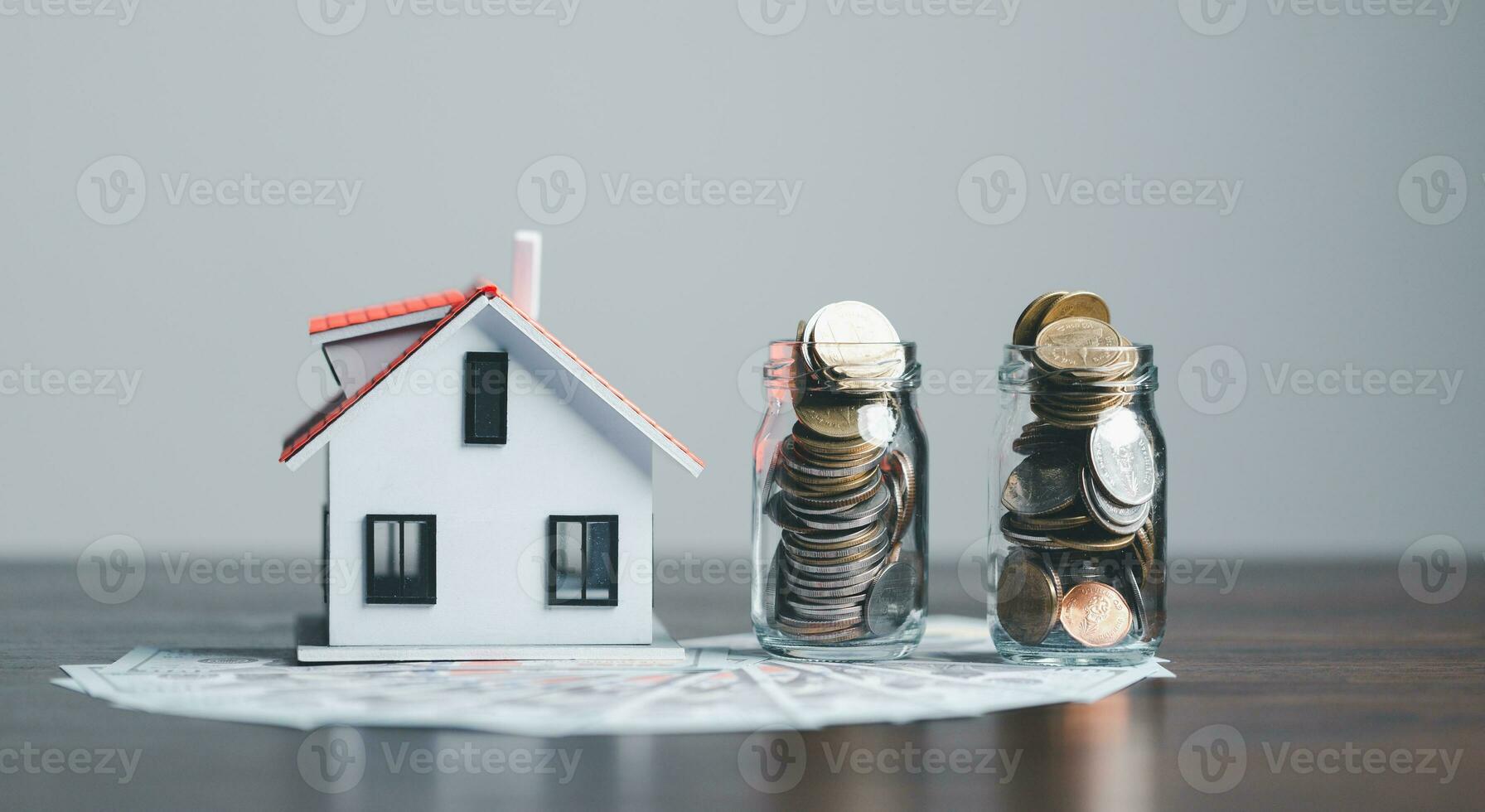 Model house with Us dollar banknotes on wooden table, home loan, Save money concept, Property investment, house loan, reverse mortgage, model home on Us dollar, saving money future for home. photo