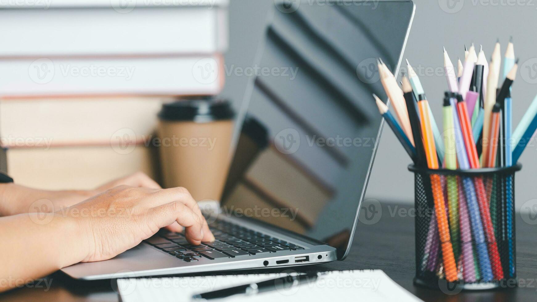 Education concept. Close up of female student make notes hand typing in laptop study online on computer from home. Woman typing in computer talking distant on webcam virtual zoom call on laptop. photo