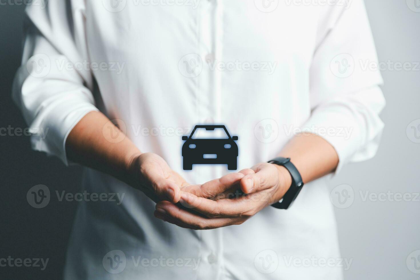 Business woman's hand protecting black icon car on desk. Planning to manage transportation finance costs. Concept of car insurance business, saving buy - sale with tax and loan for new car. photo