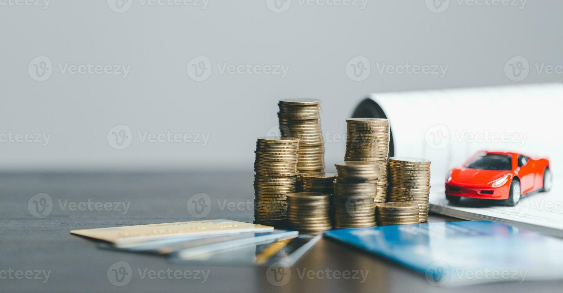 Car and house model with coins and financial document on wooden table. Asset approval concepts purchases to buy a car and a house. Ideas for home buying checklist home loan tax photo