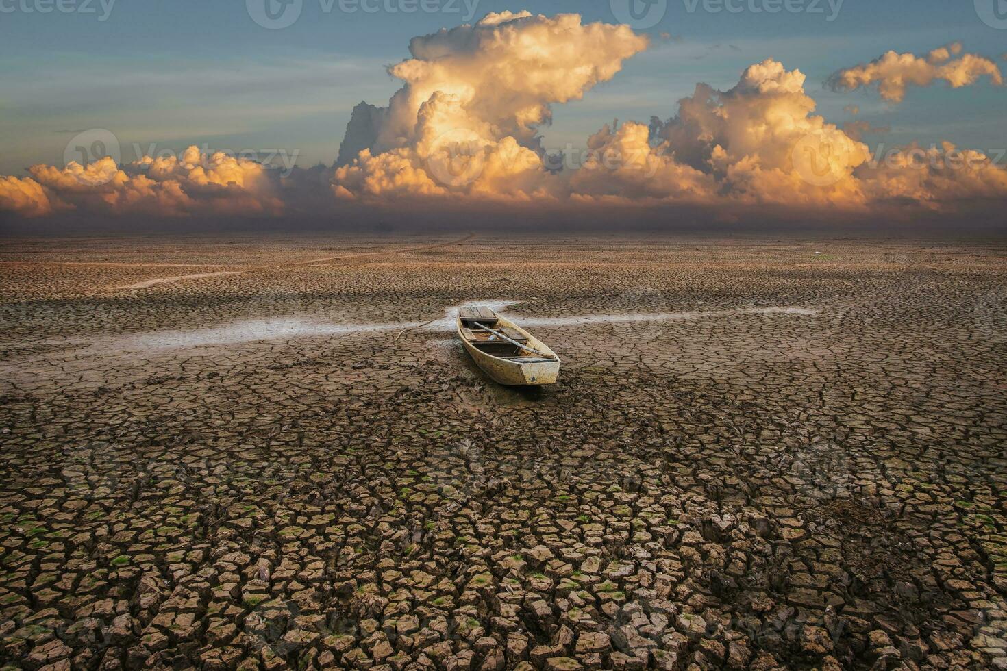 Wooden boat on Climate drought, Terrain cracked soil in hot weather photo