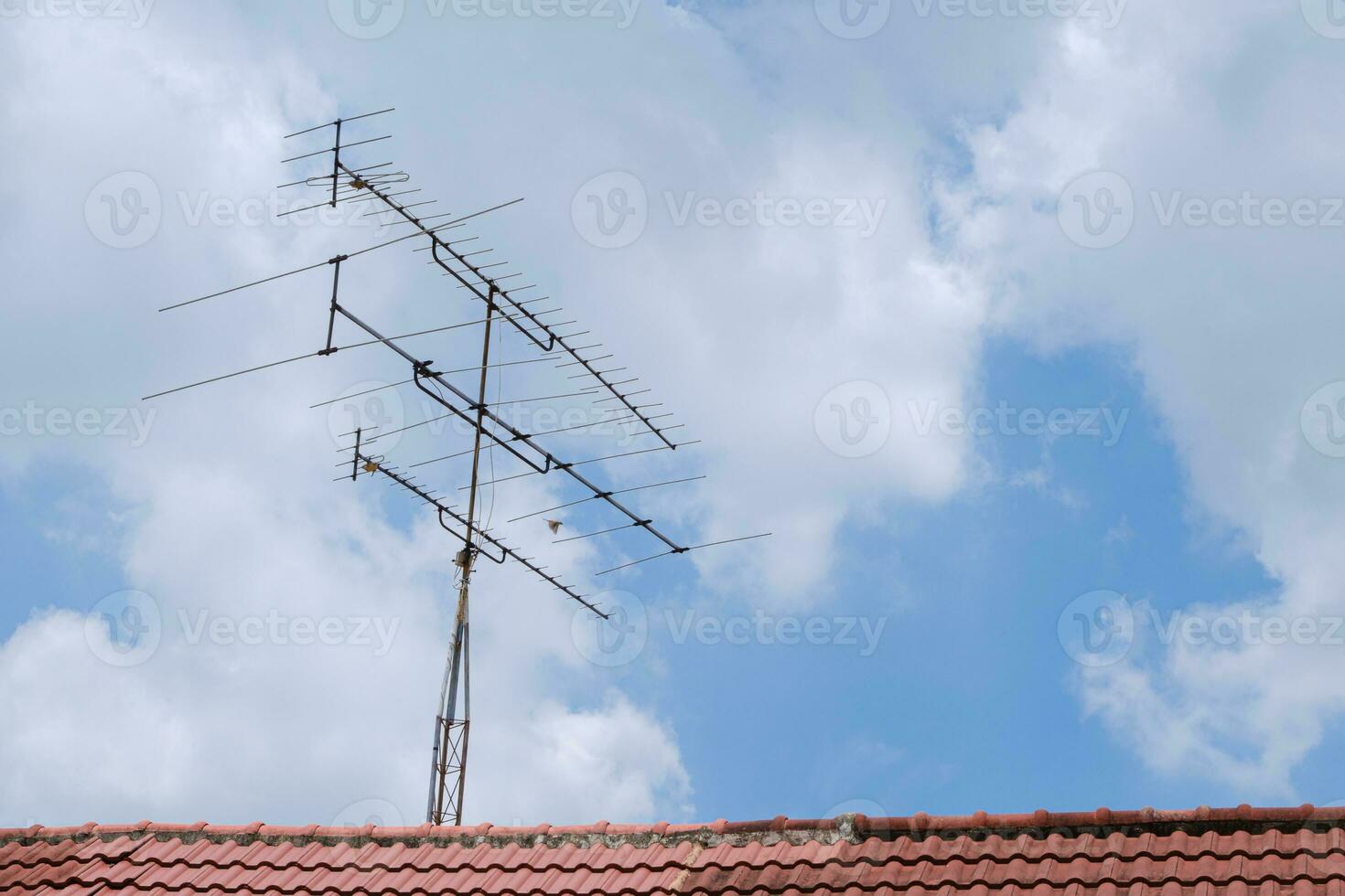 TV antenna on the roof of the house photo