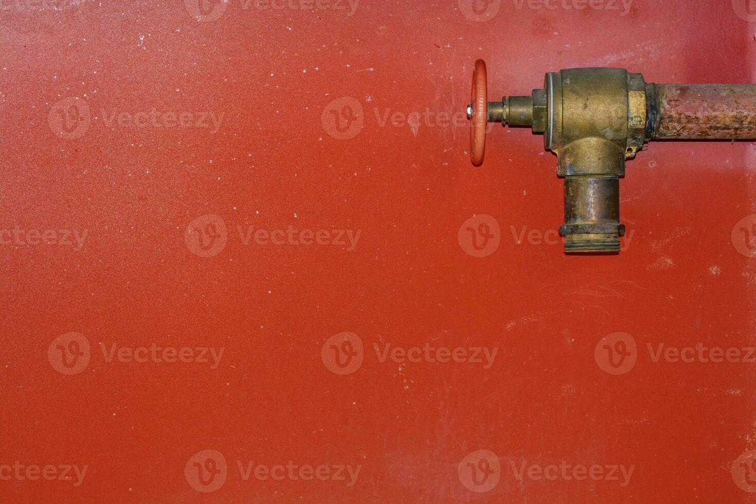 Fire hose on red background photo