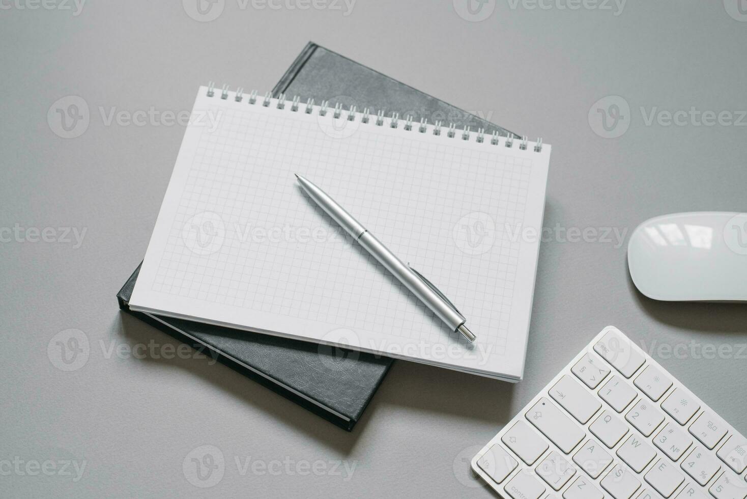 Notebooks or diaries with a blank page and a ballpoint pen on top of them. Office worker's place photo