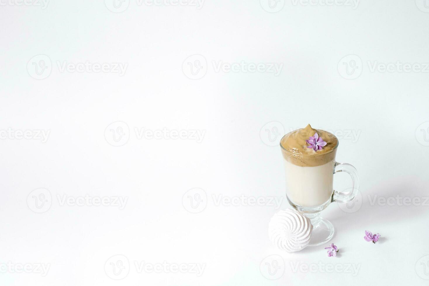 Dalgon's trending drink is coffee. Coffee mug, lilac and marshmallow on a white background. Copying space photo