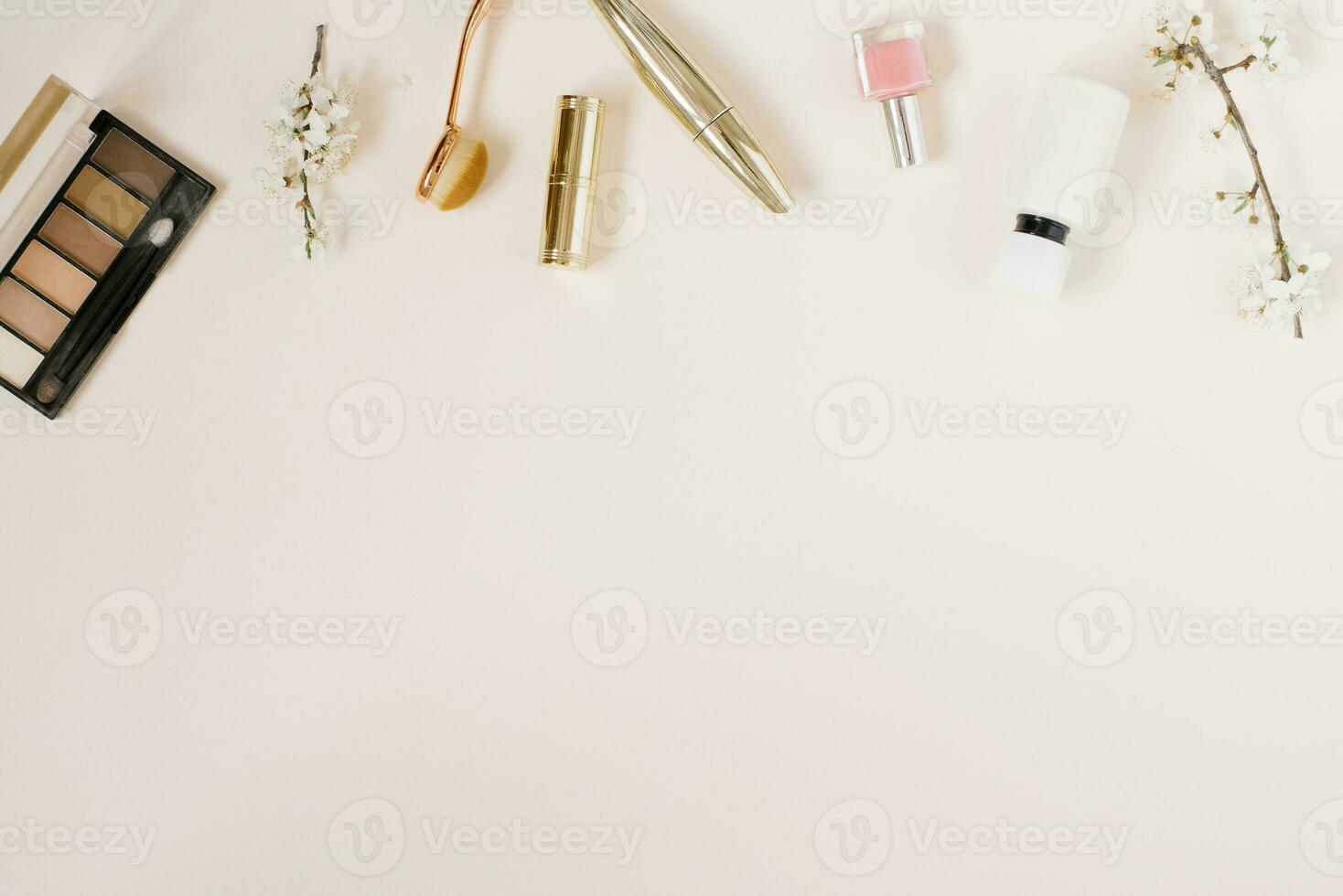 Woman background. Spring flowers and woman cosmetic on beige background. Flat lay, top view. photo
