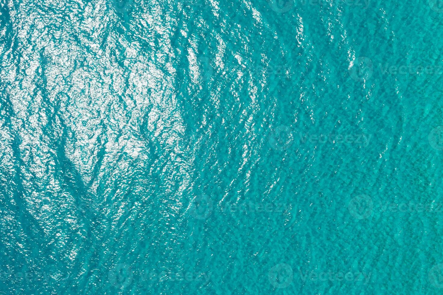 Vertical drone image on the turquoise sea surface photo