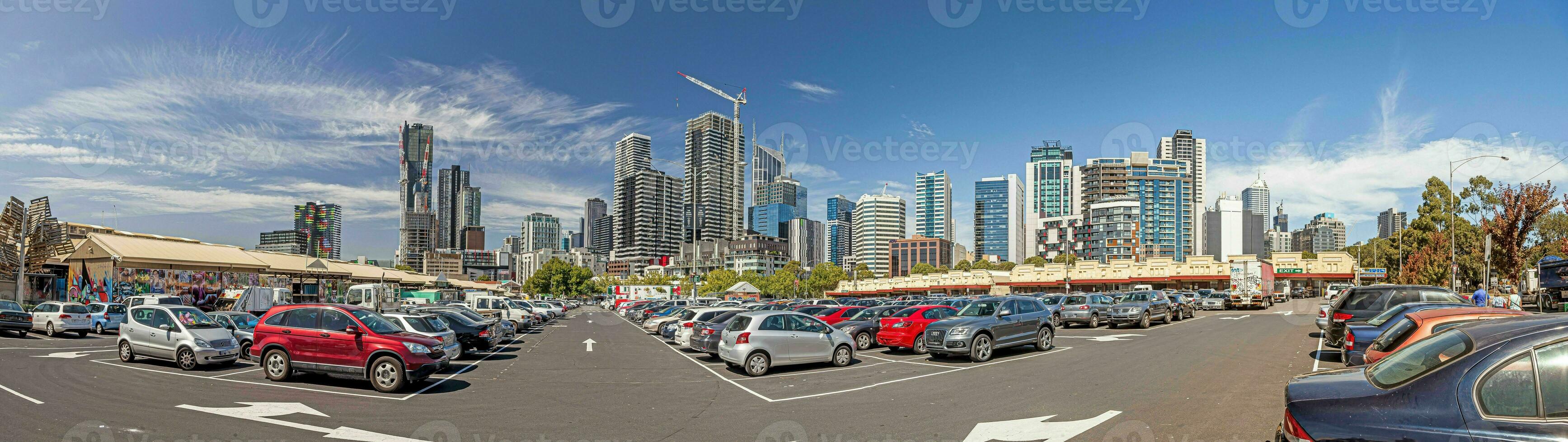 Panoramic image of Melbourne skyline taken from busy parking lot in front of shopping mall photo